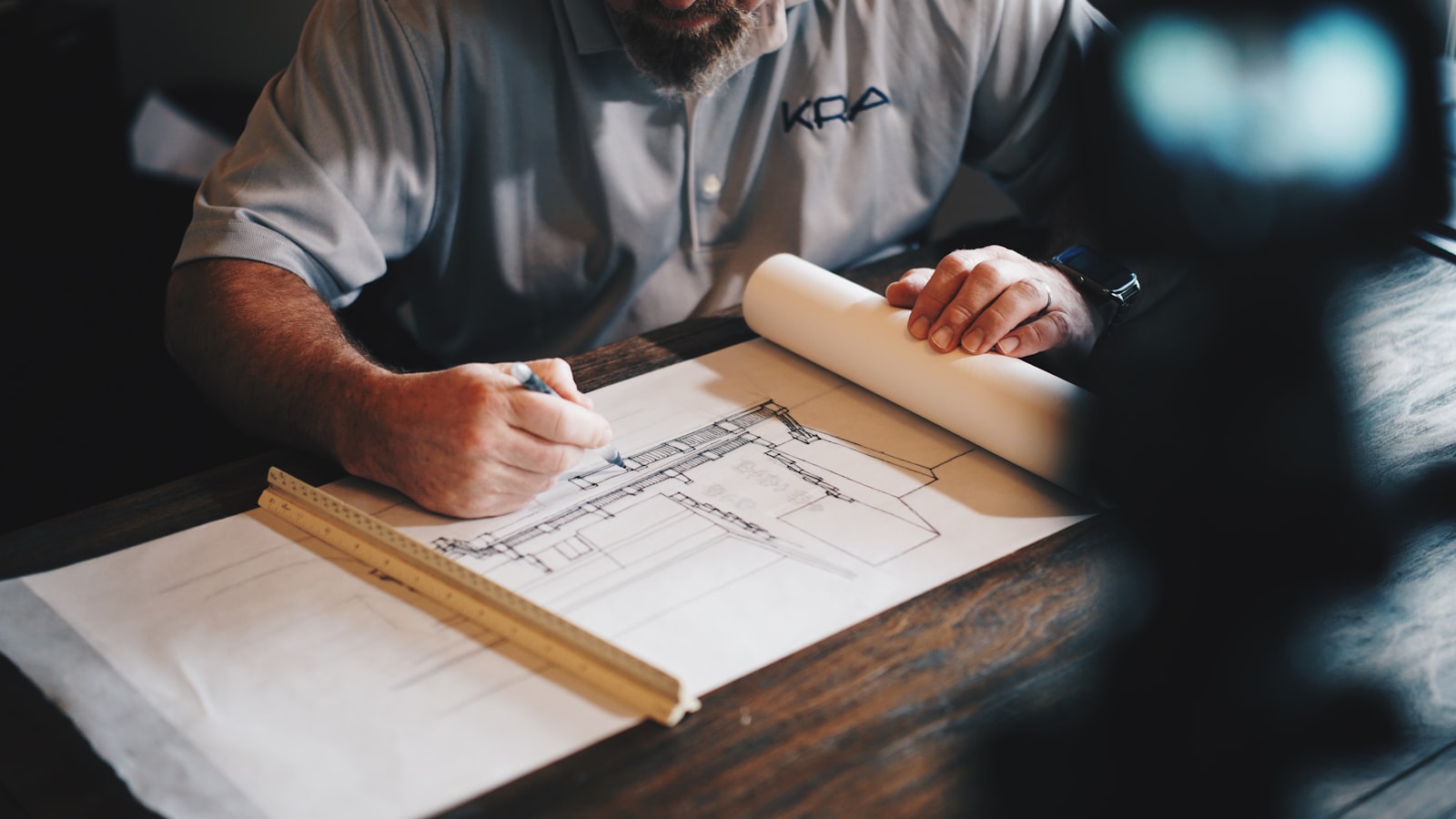 Builder drafting home plans at a work table