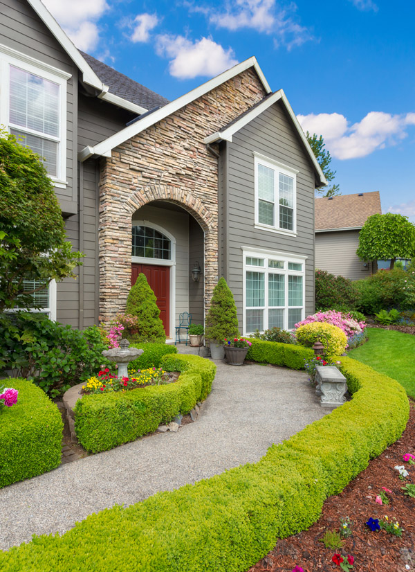 Manicured landscaping and stone walkway at a Long Island home